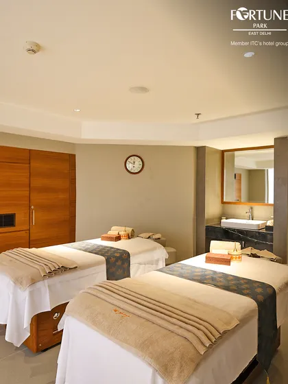 Here is another view of my couples treatment room, showcasing the clean, uncluttered space and professionally prepared massage beds ready to provide a shared, restorative experience.