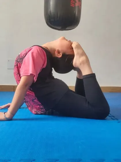 A young student demonstrates impressive flexibility, a key component of our training program. Flexibility helps in executing high kicks and preventing injuries.