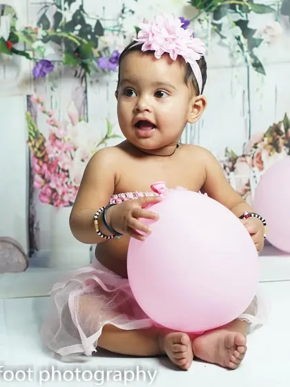 A simple and happy moment from a pre-birthday studio shoot. Sometimes all you need is a pink balloon to get the most joyful smiles.