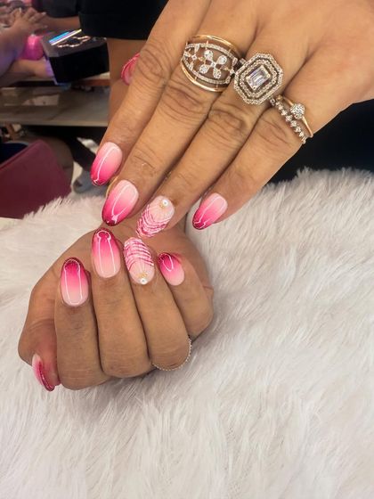 A vibrant pink ombre design that fades from a soft baby pink to a deep magenta. An accent nail with delicate white line work adds an artistic touch.
