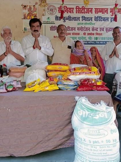 Standing with the community members and organizers during a ration distribution drive for the elderly and needy families.