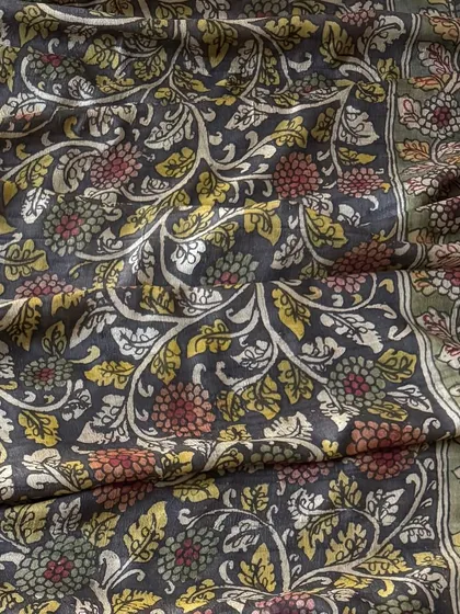 A close-up of the all-over floral jaal pattern on the silk dupatta. The use of muted red, yellow, and green vegetable dyes creates a sophisticated and earthy palette.
