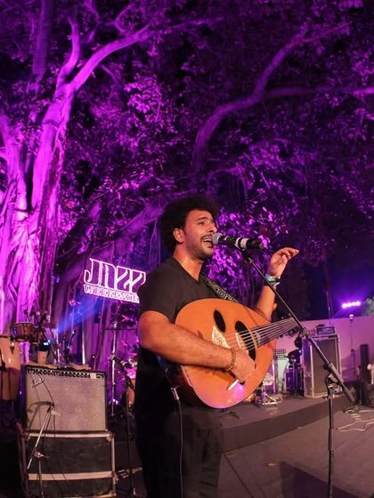 An artist performing with an oud on the main stage at Jazz Weekender. My curation focuses on showcasing a global range of instruments and musical traditions within the framework of a modern jazz festival.