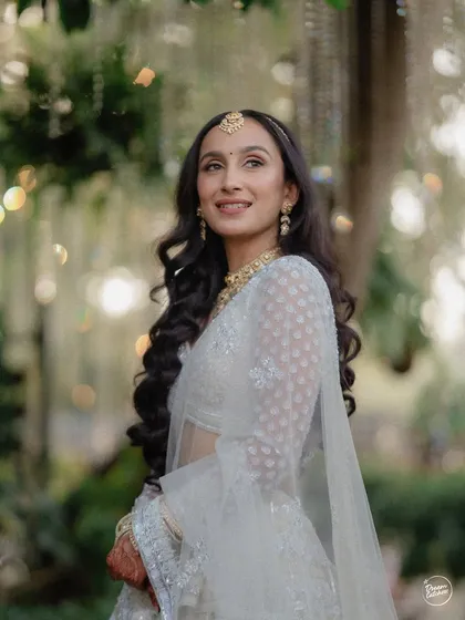 The bride looking up with a hopeful and happy expression, with beautiful bokeh from the lights in the background creating a magical atmosphere.