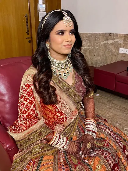 A beautiful candid shot of the bride Twinkle. Her makeup looks fresh and flawless, ensuring she feels comfortable and confident throughout her big day.