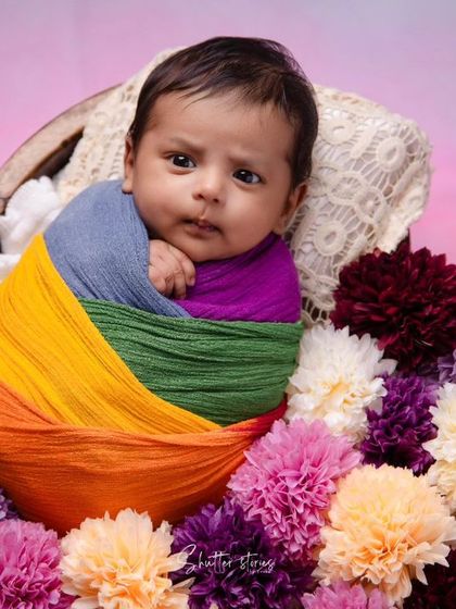 Another alert moment from the rainbow baby, showing his bright, curious eyes.