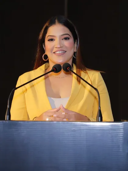 A confident smile from the podium at the Cyberguard Summit. I am comfortable and prepared, whether I'm hosting a large-scale IT conference or an intimate industry discussion.