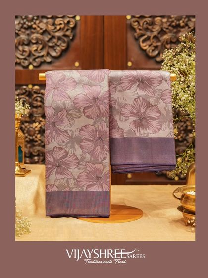 A floral woven Kanjivaram in shades of lavender and grey, offering a subtle and sophisticated take on floral patterns.