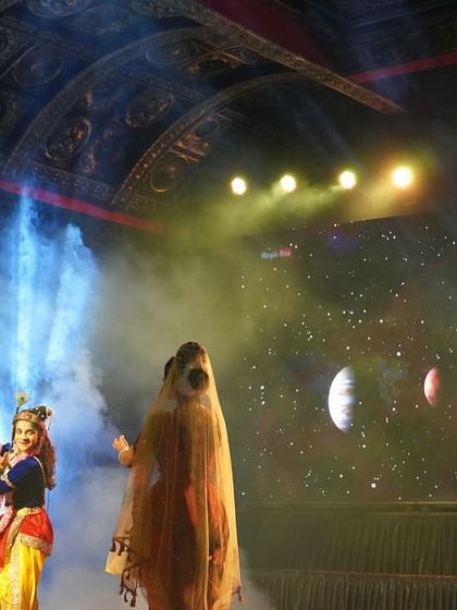 We incorporate modern technology like digital backdrops to create immersive worlds. Here, a scene from "KRISHNA" is set against a cosmic background, enhancing the mythological narrative.