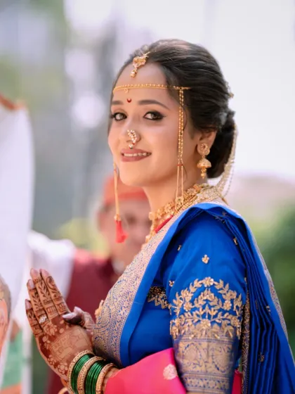 The complete Maharashtrian bridal look, from the Mundavalya across her forehead to the intricate henna on her hands. The makeup is designed to last through all the rituals, keeping her looking fresh and radiant.