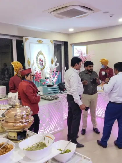 Guests interacting with our staff at a beautifully decorated counter. We are always happy to explain the dishes and assist your guests in any way we can.