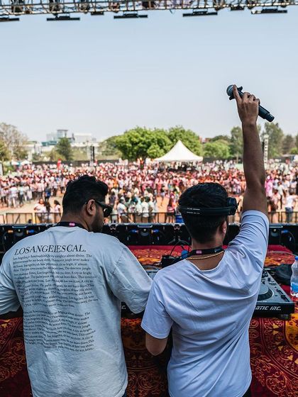 On the mic, addressing the massive crowd at the Maha Holi festival. This is me in my element, commanding a large stage.