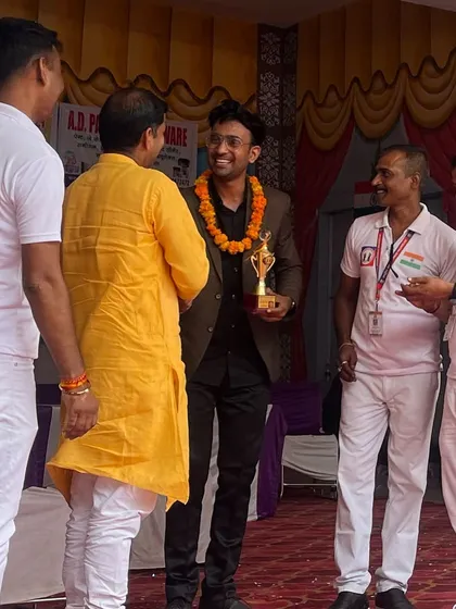 Receiving a trophy and a garland for my performance at an event for the Rashtriya Manavadhikar Foundation.