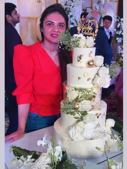 My first five-tier cake! This magical white and gold creation was for a 25th anniversary. It featured floating tiers with lights, delicate gold leaf, and a cascade of white roses. The top tiers were chocolate mousse and the bottom was classic pineapple.