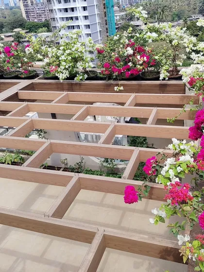 The custom pergola structure on this terrace is designed with built-in planters, creating a unique multi-level gardening space.