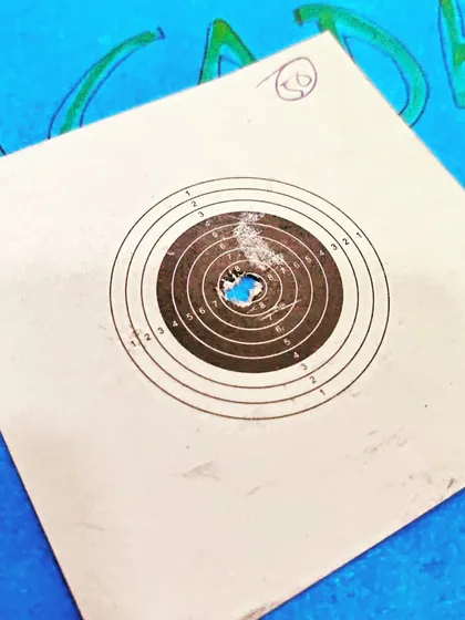 A close-up of a well-aimed shot on a target card. The goal is to replicate this precision with every single shot.