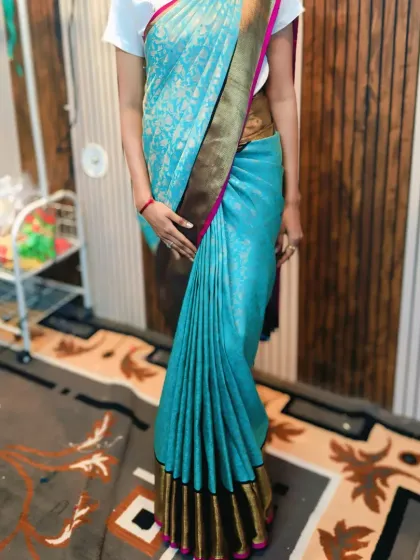A beautifully draped light blue silk saree, showcasing how perfect pleats create a slim and elegant look. This is the result of my meticulous pre-pleating and styling service.