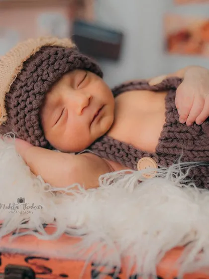 So tiny and perfect. This close-up shot highlights the beautiful, peaceful expression of a sleeping newborn, a memory to treasure forever.