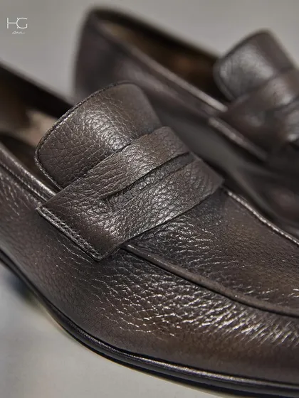 Another detail shot of the leather loafers, showcasing the fine texture and the classic, timeless design that makes them a staple for any wardrobe.