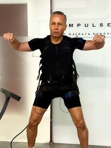 This client demonstrates an isometric hold, with the EMS suit creating intense muscle contractions even without movement.