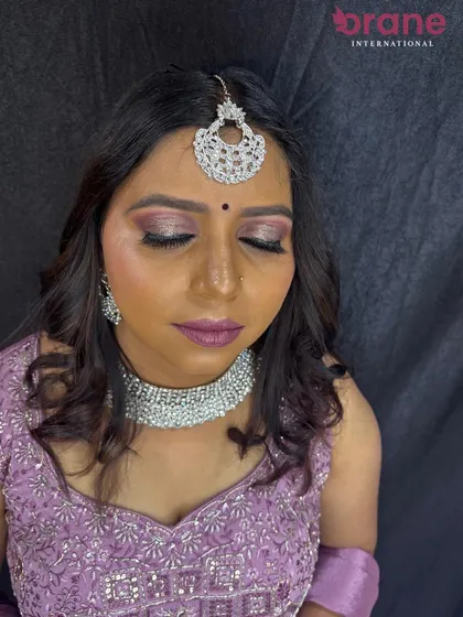 A serene close-up of the reception makeup, highlighting the soft, shimmering details.