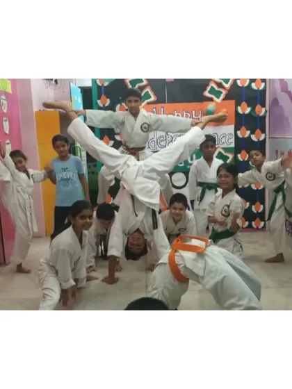 A dynamic group pose showing a variety of skills, from handstands to high kicks, all part of our fun and engaging training for kids.