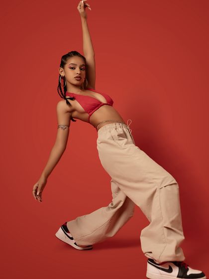 A graceful, long-limbed pose reaching upwards, showing my extension and control.