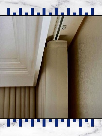 A close-up of our curtain track, seamlessly integrated with the crown moulding. It's a small detail that ensures a clean, high-end finish.