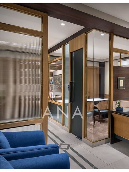 This view showcases the use of fluted glass and brass-framed partitions in the Jain Cosphere Office. These materials provide a sense of luxury and privacy, catering to the client's dual business sectors.