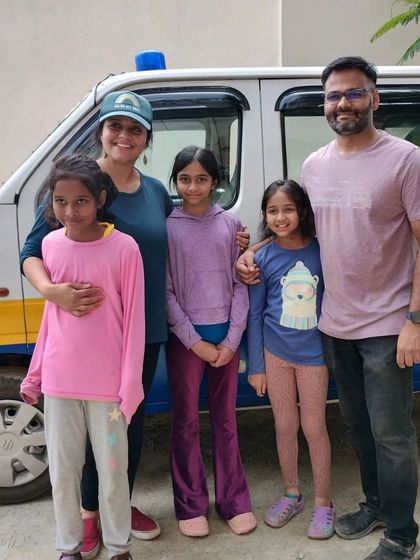 A family of supporters stands proudly in front of one of our pet ambulances. We are so thankful for families who teach their children about compassion and animal welfare.