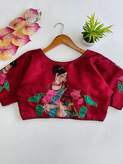 A pure silk blouse in maroon with an elegant all-over print and antique handcrafted detailing.