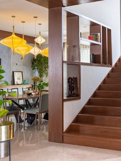 A view from the staircase looking towards the dining area. The built-in shelving next to the stairs is a clever use of space, providing display niches for art and books.