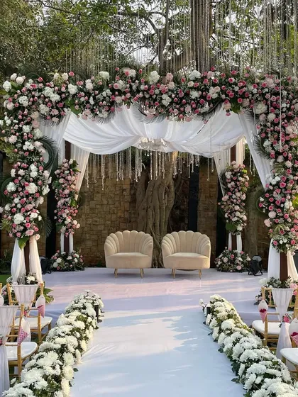 A fairytale setting for a nikah or pheras. This pastel pink and white floral arch creates a soft, romantic focal point, perfect for an elegant daytime ceremony.