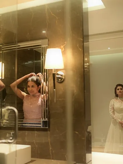 A glimpse into the getting-ready process. Creating the perfect bridal updo for her Christian wedding.