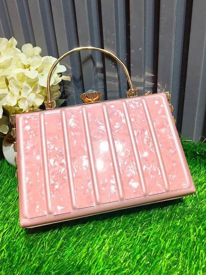 This pink, vertically striped box clutch with a gold handle is a chic and structured accessory for any party look.