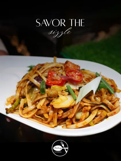 A close up of my Udon Noodles tossed in a vibrant vegetable yellow sauce. The thick, chewy noodles are combined with fresh, crisp vegetables, offering a comforting and flavourful dish from my Japanese Teppanyaki menu.