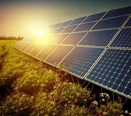 A ground-mounted solar farm at sunset. We help businesses unlock a world of sustainability and cost savings through the power of solar, propelling them toward a greener and more efficient future.