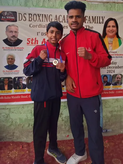 One of my young boxers with his coach after winning a medal at the DS Boxing League in Najafgarh. We celebrate every achievement.