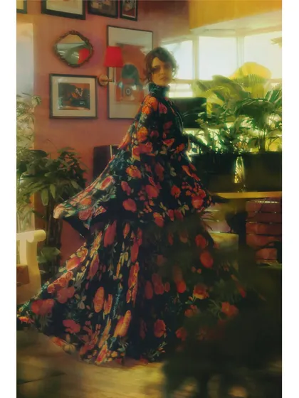 A motion-blur shot from 'The Wait', capturing the swirl of the floral dress. This technique visually represents the feeling of being lost in a memory, where details are soft and dreamlike.