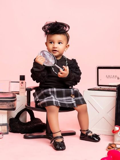 A duplicate of a previous shot, this image captures the little fashionista admiring her reflection, a perfect moment in her special birthday session.