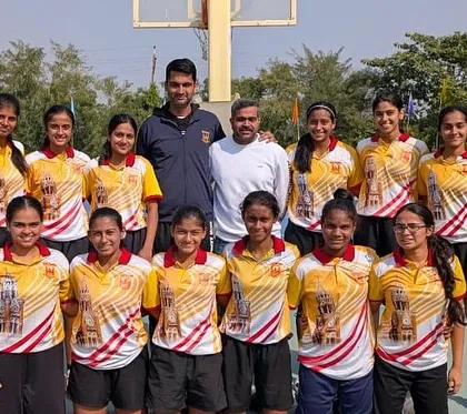 A formal team photograph of the Mumbai University women's basketball team. Posing with the team and officials, this picture represents our collective effort and preparation for the West Zone tournament.