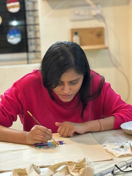 A participant painting a custom design on a tote bag during a private Valentine's event. These sessions are for everyone, whether it's with a partner, friend, or just for yourself.