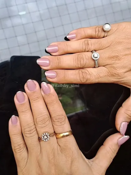 A glitter French manicure is all you need to slay your nail game. This design features a mix of black and white glittery tips.