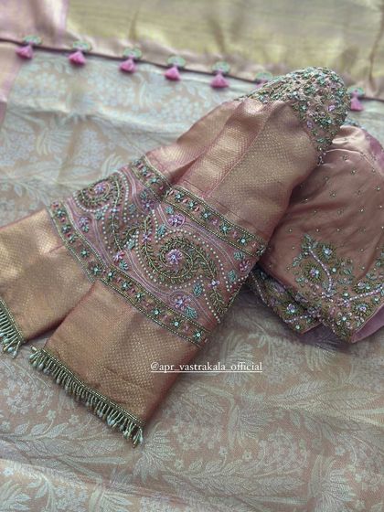 A close-up of the paisley embroidery on the dusty pink sleeves.