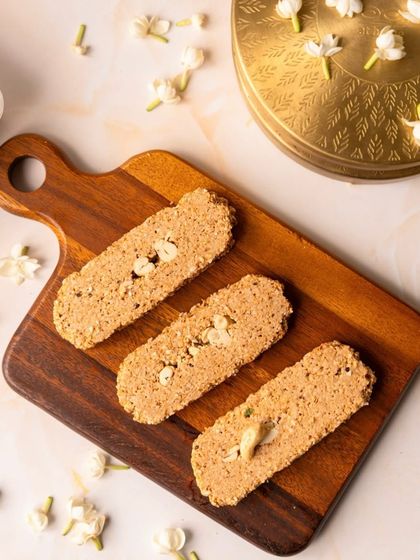 My Soam Gajak, seen here on a wooden board with jasmine flowers, is crafted to bring you the perfect blend of tradition, taste, and winter comfort.