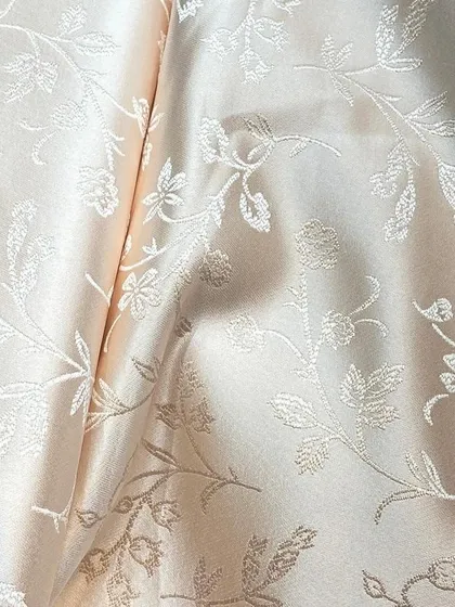 An elegant cream-on-cream floral jacquard fabric that offers a subtle and sophisticated option for a custom-tailored sherwani or blazer.