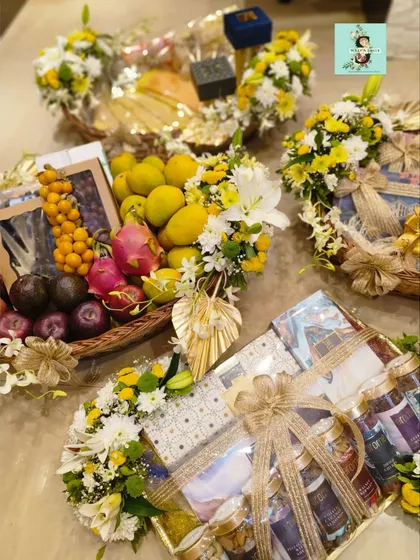 For a Roka ceremony, I designed this vibrant hamper bursting with fresh tropical flowers in yellow and white. It combines exotic fruits and other thoughtful gifts, creating a beautiful and auspicious start to the wedding festivities.