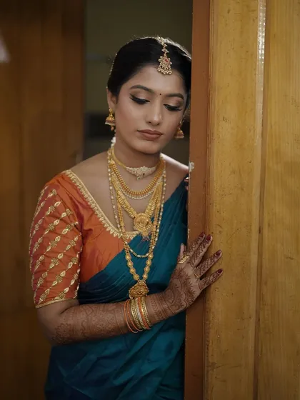 A final, quiet moment. The soft lighting highlights the delicate shimmer on her eyelids and the smooth texture of her skin, a result of careful HD makeup application.