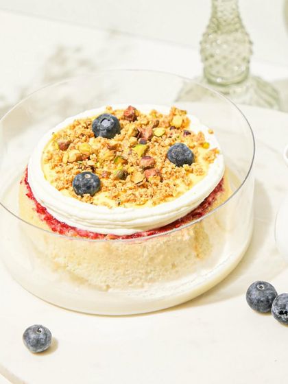 A close-up of the Lemon Berry Tres Leches, showing the crunchy topping and fresh berries.