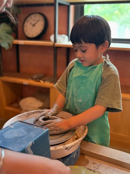 Look at the focus on this little artist's face. Our kids' sessions are all about giving children a chance to get their hands messy, build patience, and create something they can be proud of.